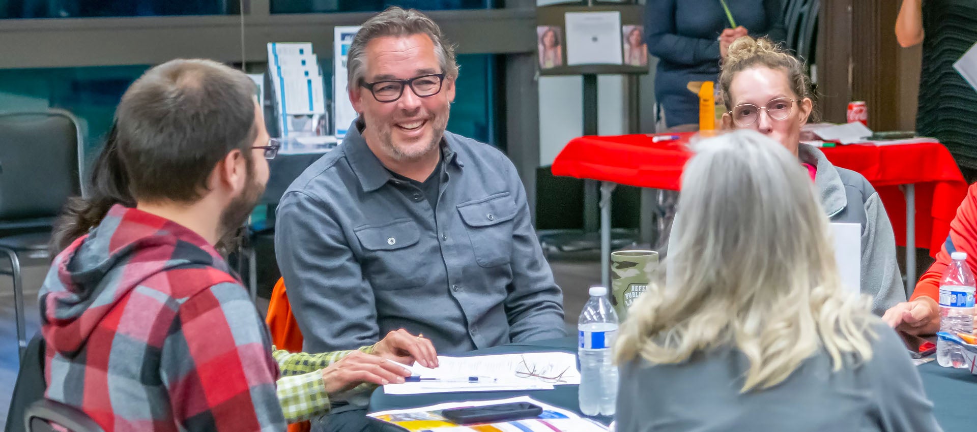Councilmember and community members at a table discussion