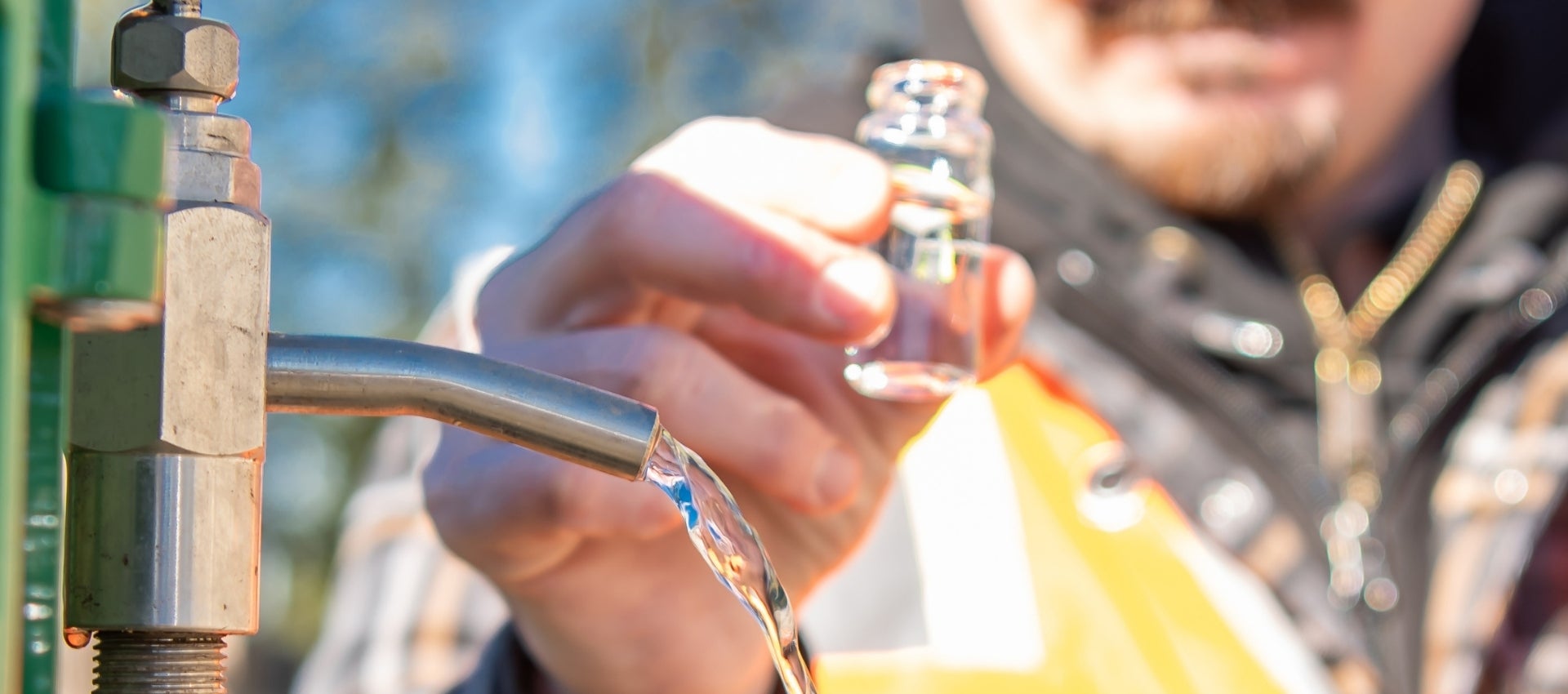 A City employee examines a water sample.