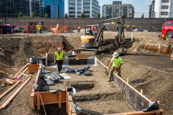 Construction crew working on leveling ground for new building