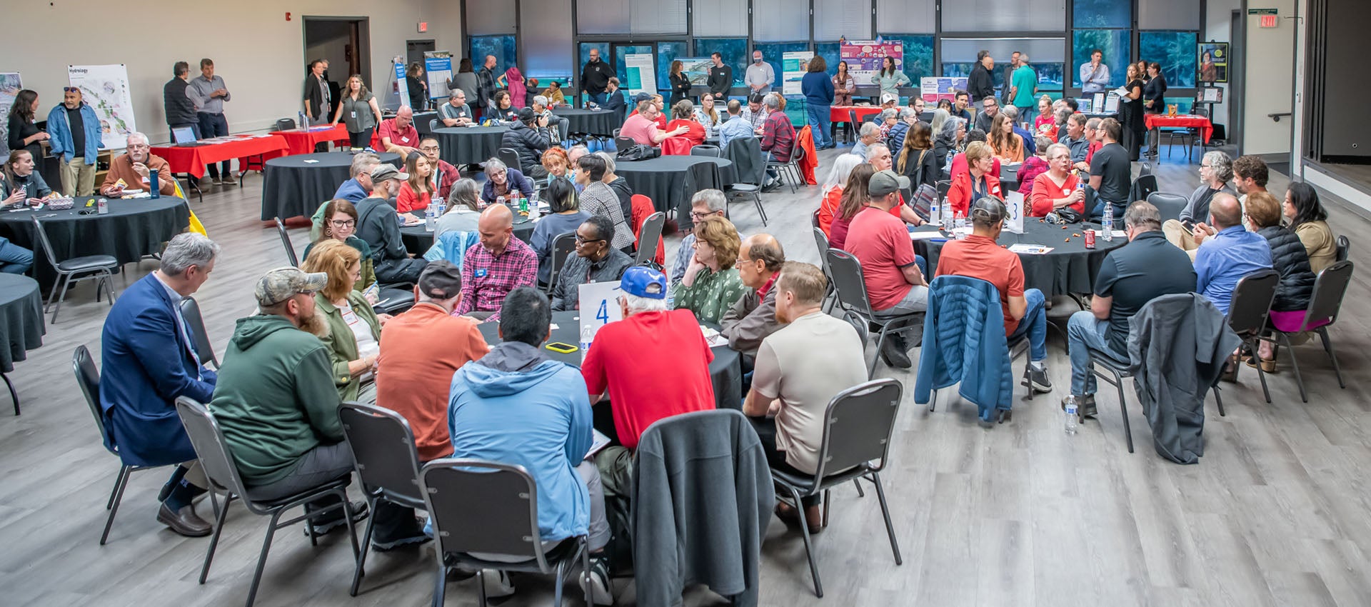 Community members sit around a table at a meeting.
