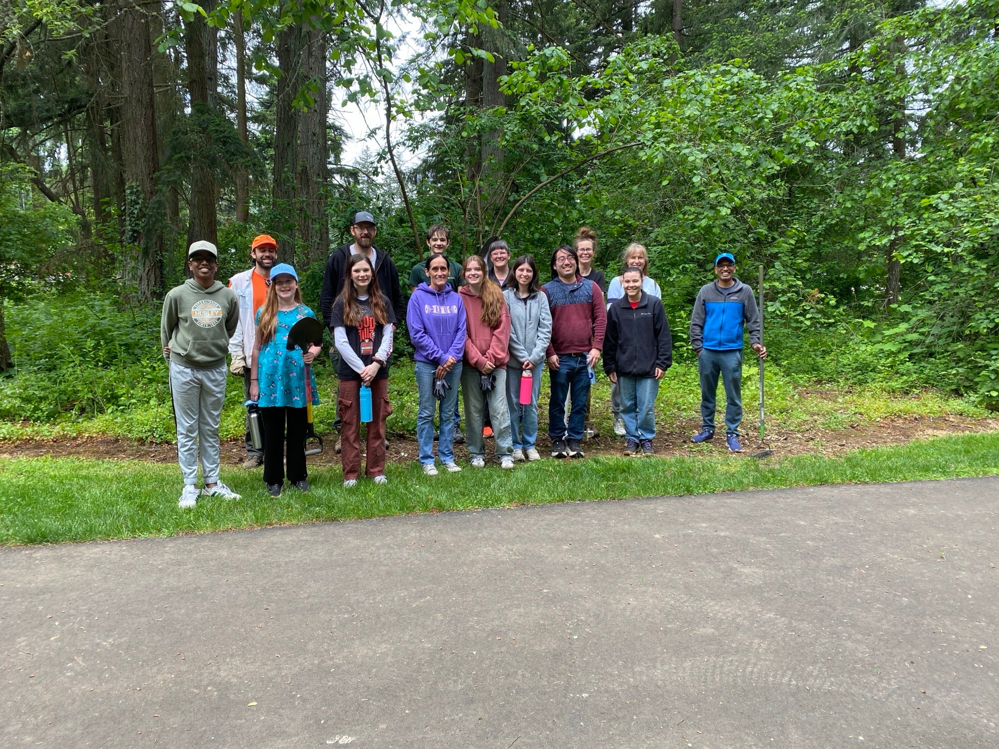 A group of volunteers smiling after a park cleanup event