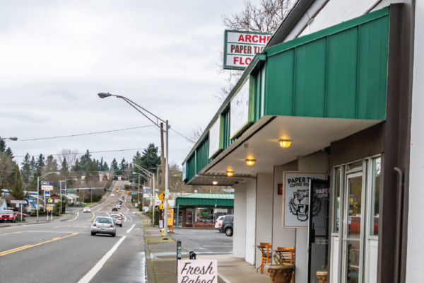 Coffee shop and sidewalk sign advertising Fresh Baked Cinnamon Rolls
